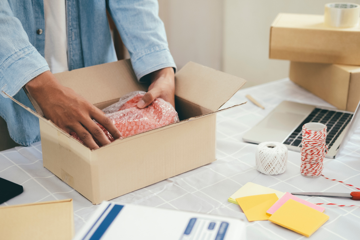 Person Packing Merchandise for Shipping